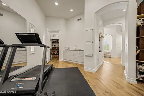 a bedroom with a bed flat screen tv and a window