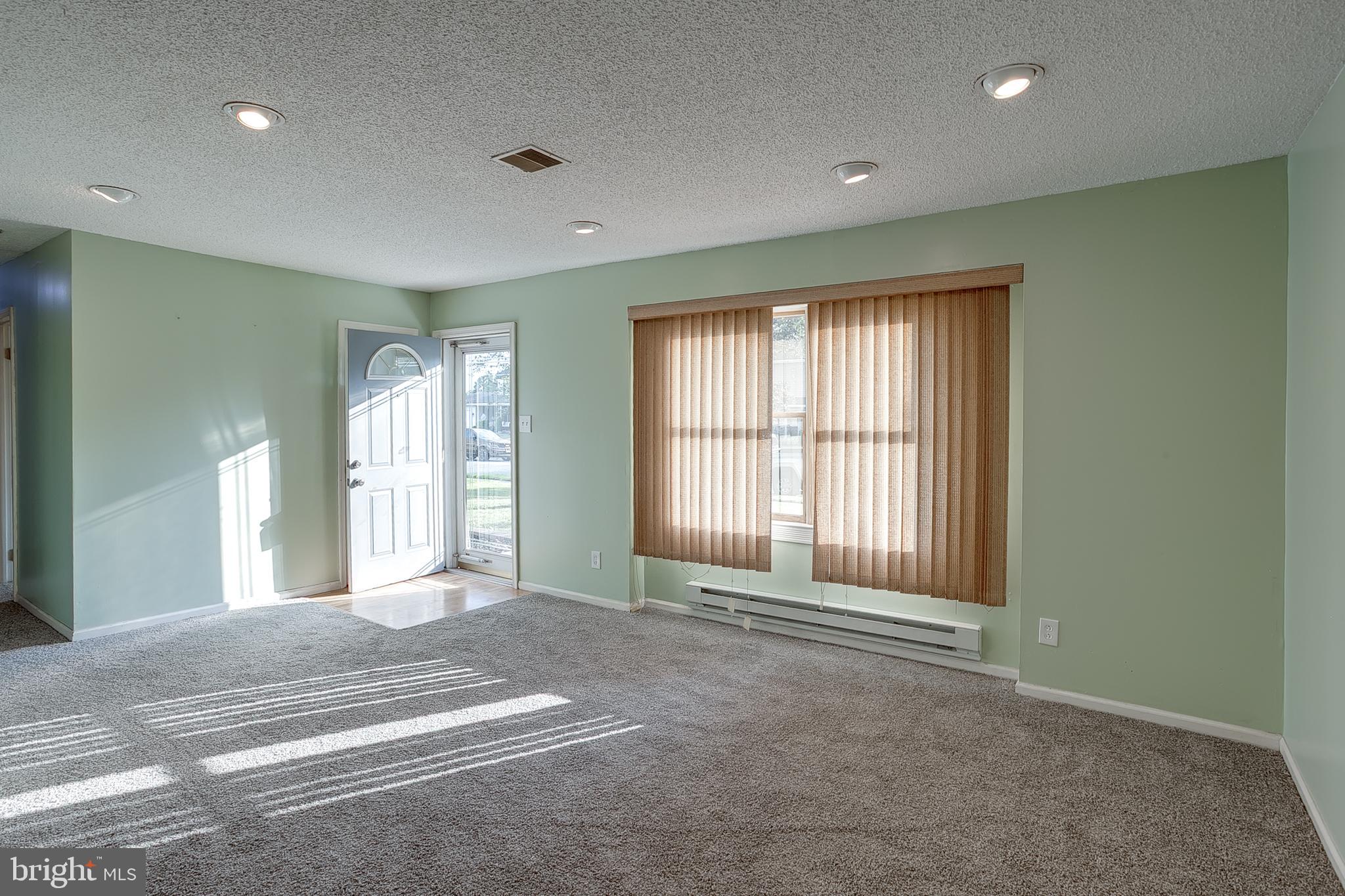 123 Wyndmere Road Marlton, NJ 08053 - Photo 4 of 31 a view of an empty room with a fireplace and a window