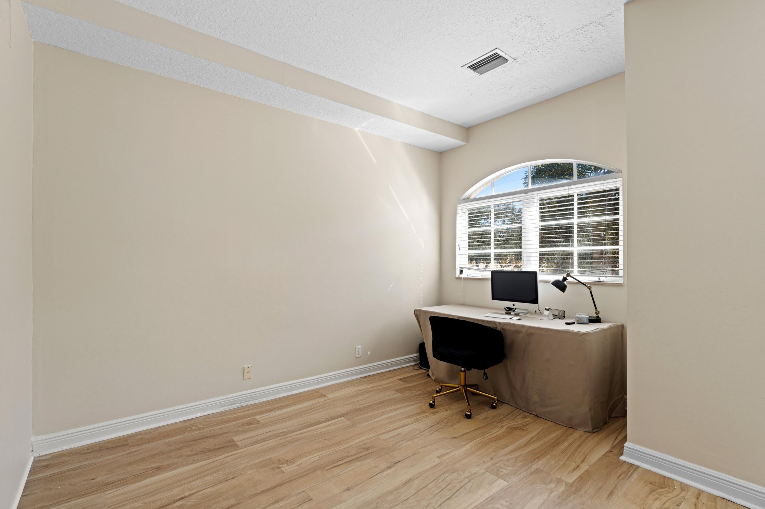 230 Northeast 69th Circle Boca Raton, FL 33487 - Photo 23 of 49 a view of a workspace with furniture and a window