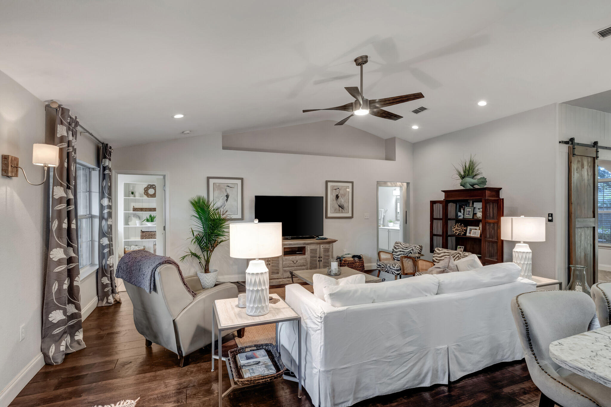 66 Driftwood Point Road Santa Rosa Beach, FL 32459 - Photo 13 of 72 a living room with furniture a ceiling fan and a flat screen tv
