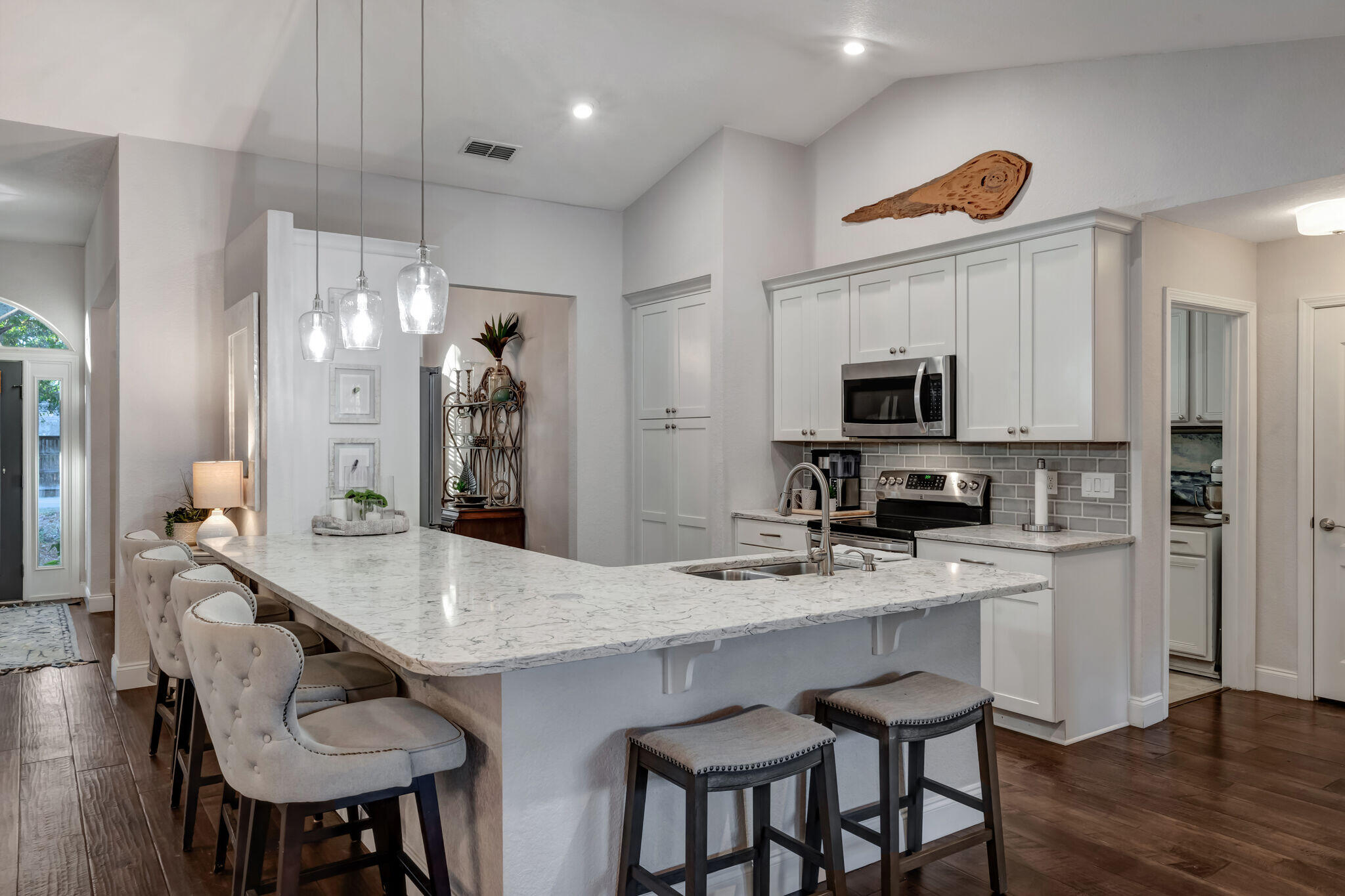 66 Driftwood Point Road Santa Rosa Beach, FL 32459 - Photo 17 of 72 a kitchen with stainless steel appliances granite countertop a sink a stove a dining table and chairs