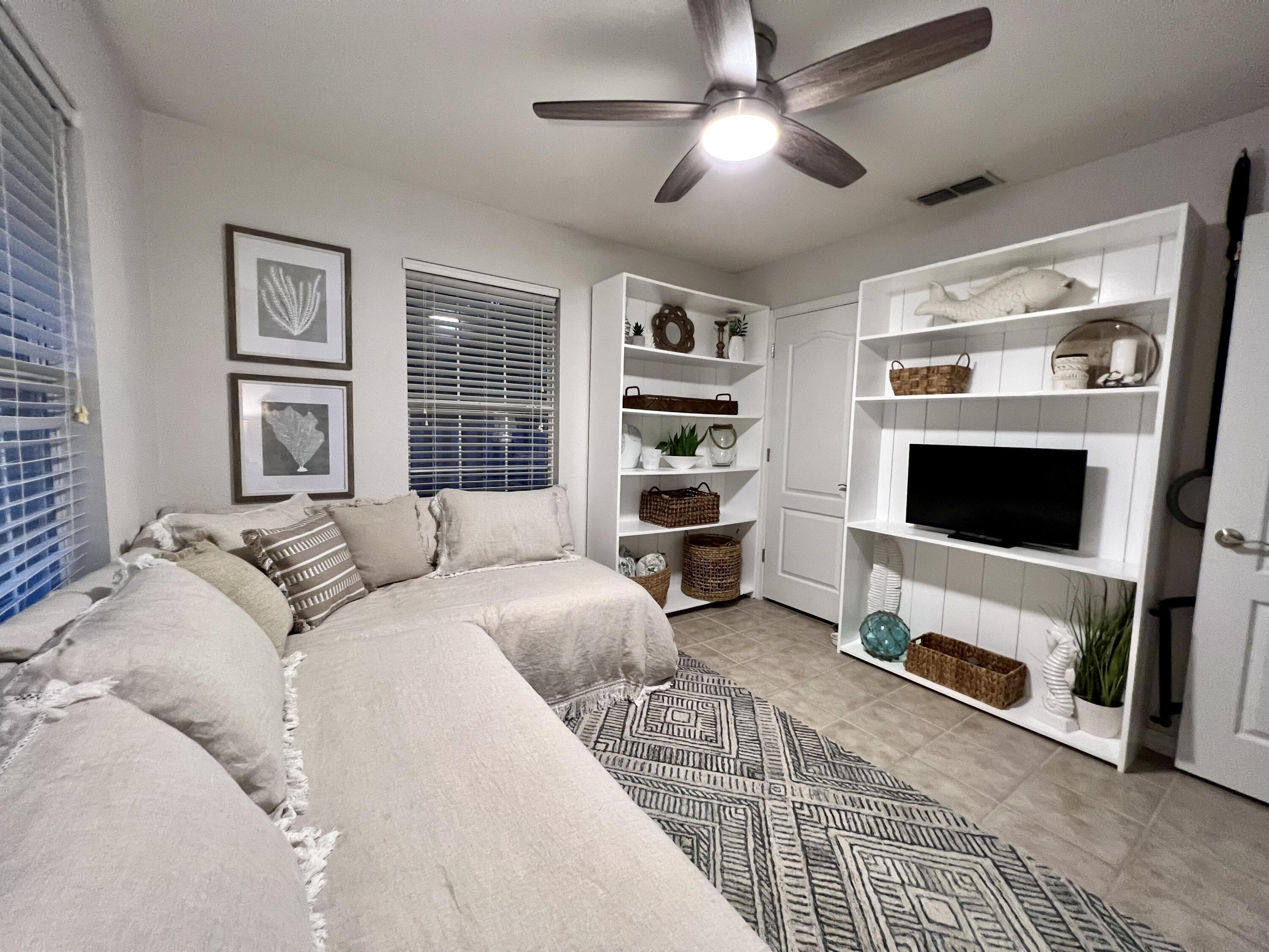 66 Driftwood Point Road Santa Rosa Beach, FL 32459 - Photo 35 of 72 a living room with furniture and a flat screen tv