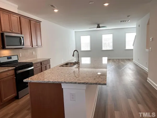 a kitchen with sink and microwave
