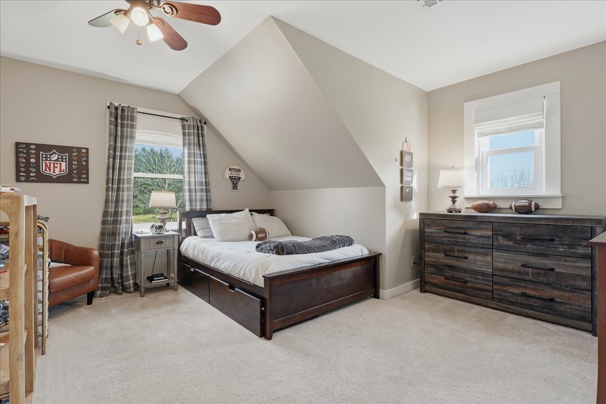 2254 Osburn Road Arrington, TN 37014 - Photo 28 of 55 a spacious bedroom with a bed and a chandelier