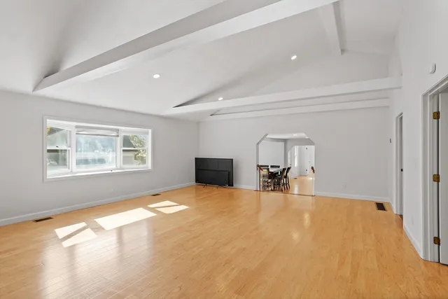 a view of empty room with fireplace and window