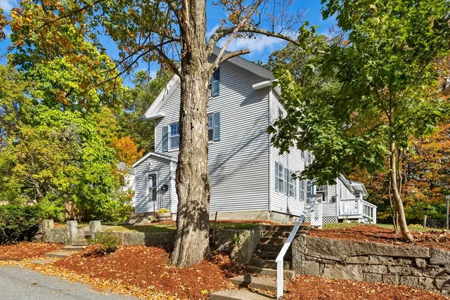 a backyard of a house with table and chairs
