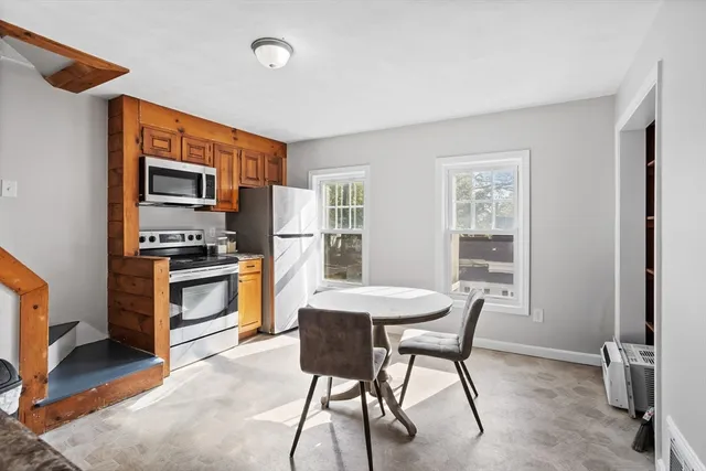 a kitchen with a refrigerator and a stove top oven