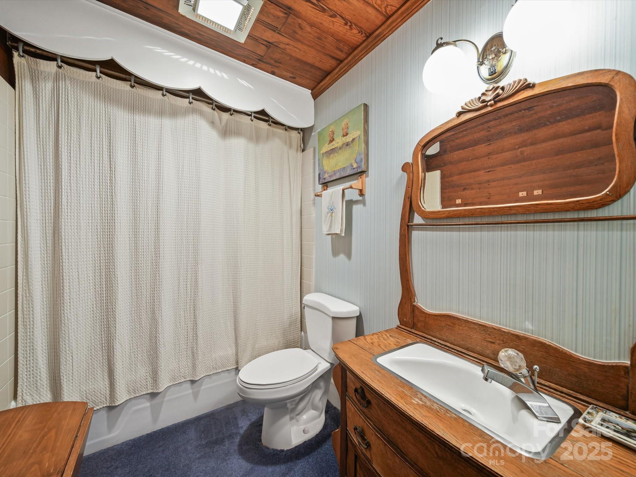 16801 Randalls Ferry Road Norwood, NC 28128 - Photo 27 of 48 a bathroom with a sink a toilet and shower curtain