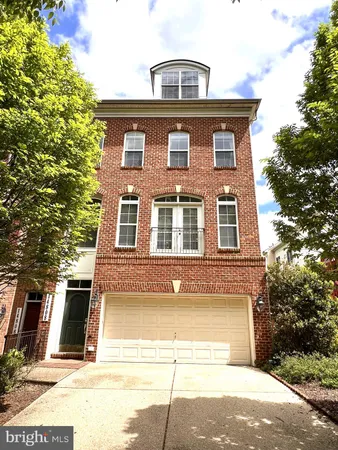a front view of a house with a tree