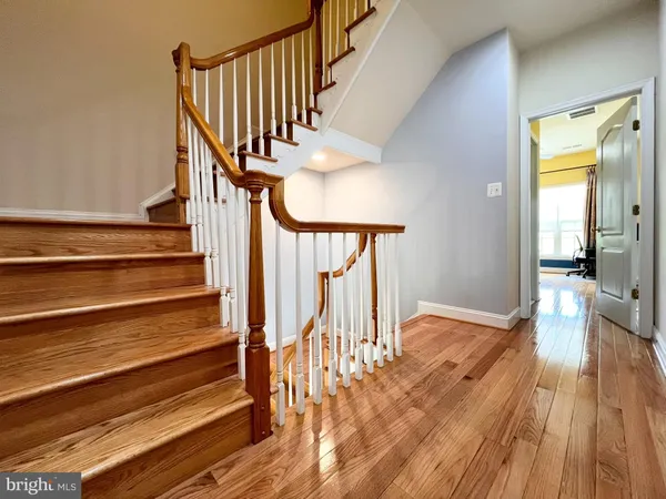 a view of entryway and hall with wooden floor