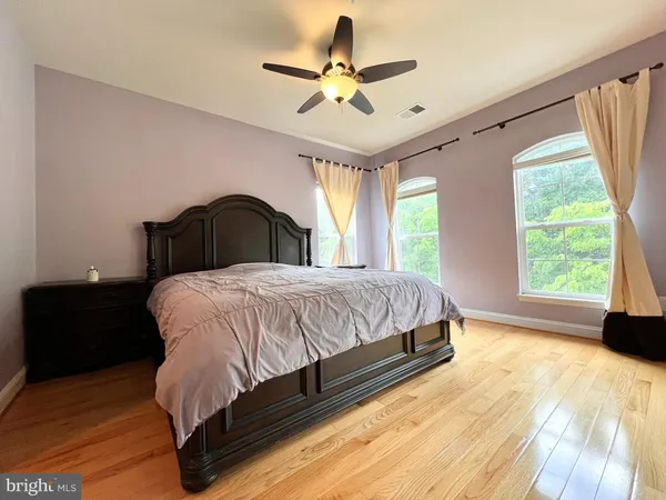 a bedroom with a bed mirror and window