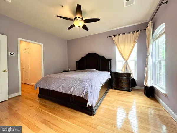 a bedroom with a large bed and a chandelier