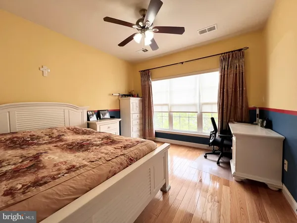 a spacious bedroom with a bed and a table