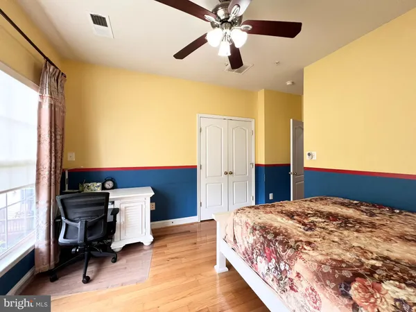 a bedroom with a bed and a desk