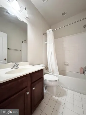 a bathroom with a sink a toilet a mirror and shower