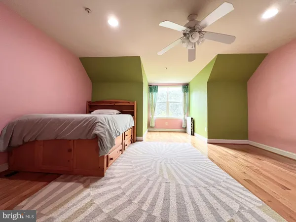 a spacious bedroom with a bed and a chandelier