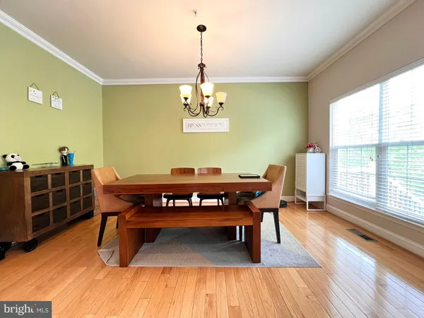 a sitting area with furniture and wooden floor