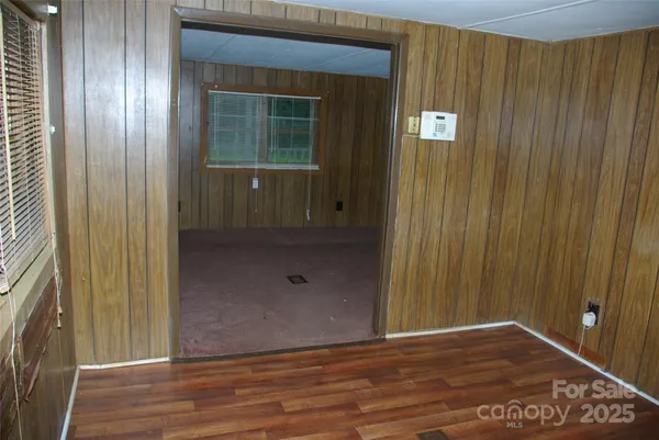 a kitchen with granite countertop a refrigerator a stove and wooden floor