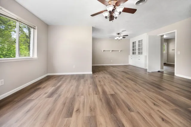 wooden floor in an empty room with a window