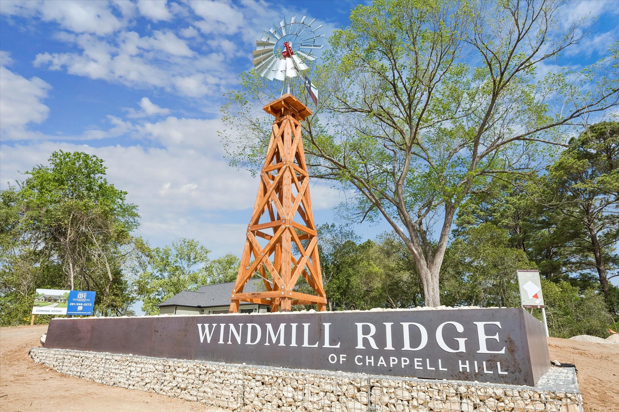 1 Windmill Ridge Brenham, TX 77833 - Photo 2 of 29 a street sign on a wall next to a road
