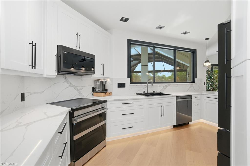1506 Jewel Naples, FL 34102 - Photo 11 of 49 a kitchen with a sink stove and microwave