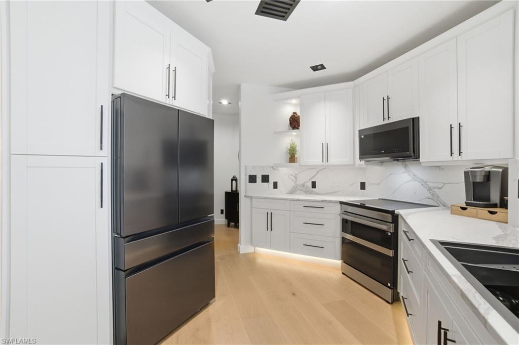 1506 Jewel Naples, FL 34102 - Photo 12 of 49 a kitchen with stainless steel appliances and refrigerator