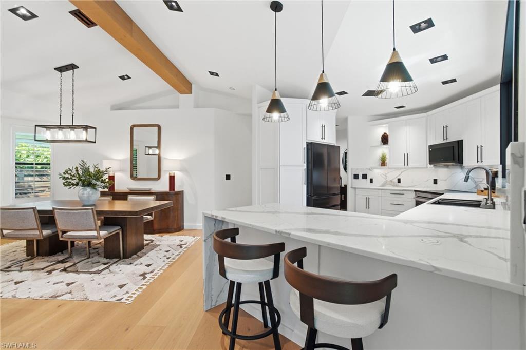1506 Jewel Naples, FL 34102 - Photo 14 of 49 a kitchen with stainless steel appliances kitchen island granite countertop a sink and cabinets