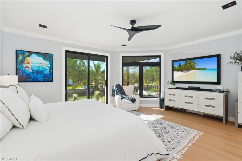 1506 Jewel Naples, FL 34102 - Photo 19 of 49 a bedroom with furniture and a flat screen tv