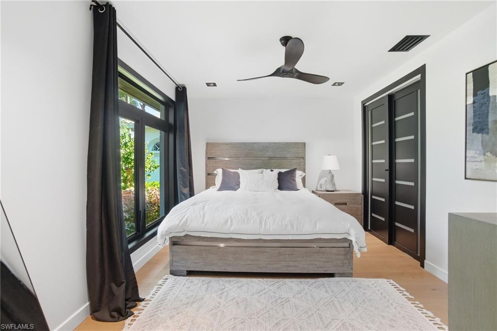 1506 Jewel Naples, FL 34102 - Photo 22 of 49 a bed room with a bed and a large window