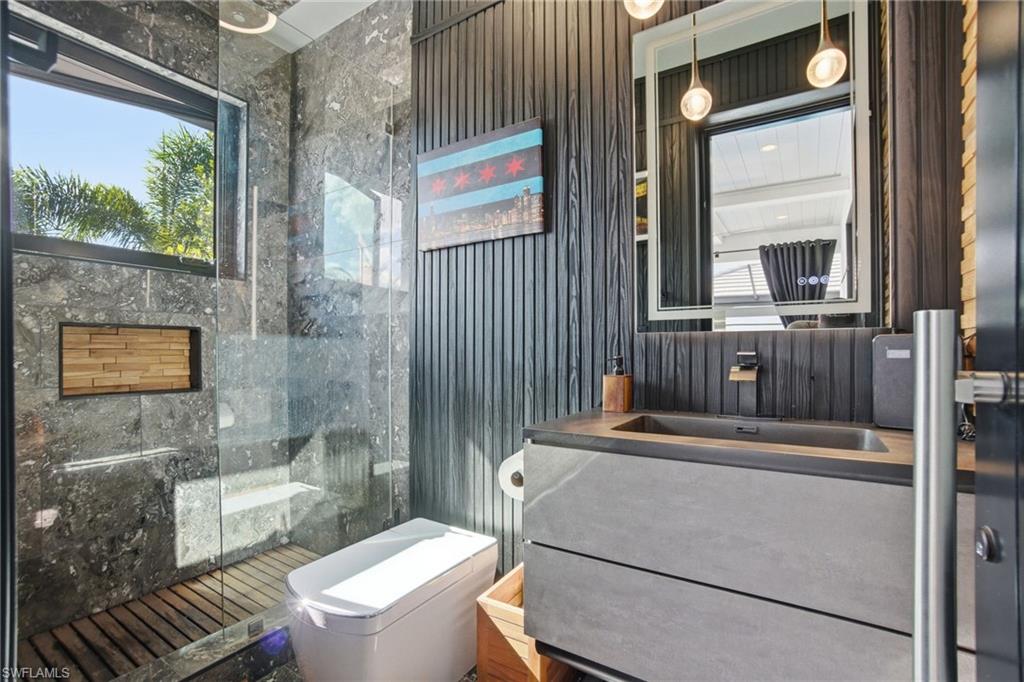 1506 Jewel Naples, FL 34102 - Photo 29 of 49 a bathroom with a toilet a sink and a mirror