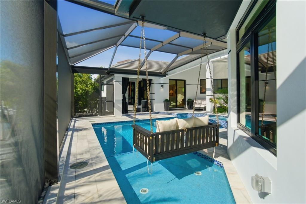 1506 Jewel Naples, FL 34102 - Photo 30 of 49 a view of a patio with a table and chairs
