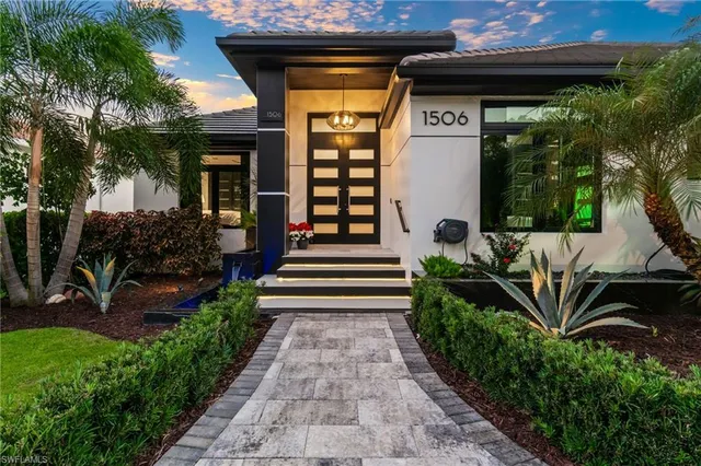 a front view of a house with garden and seating area