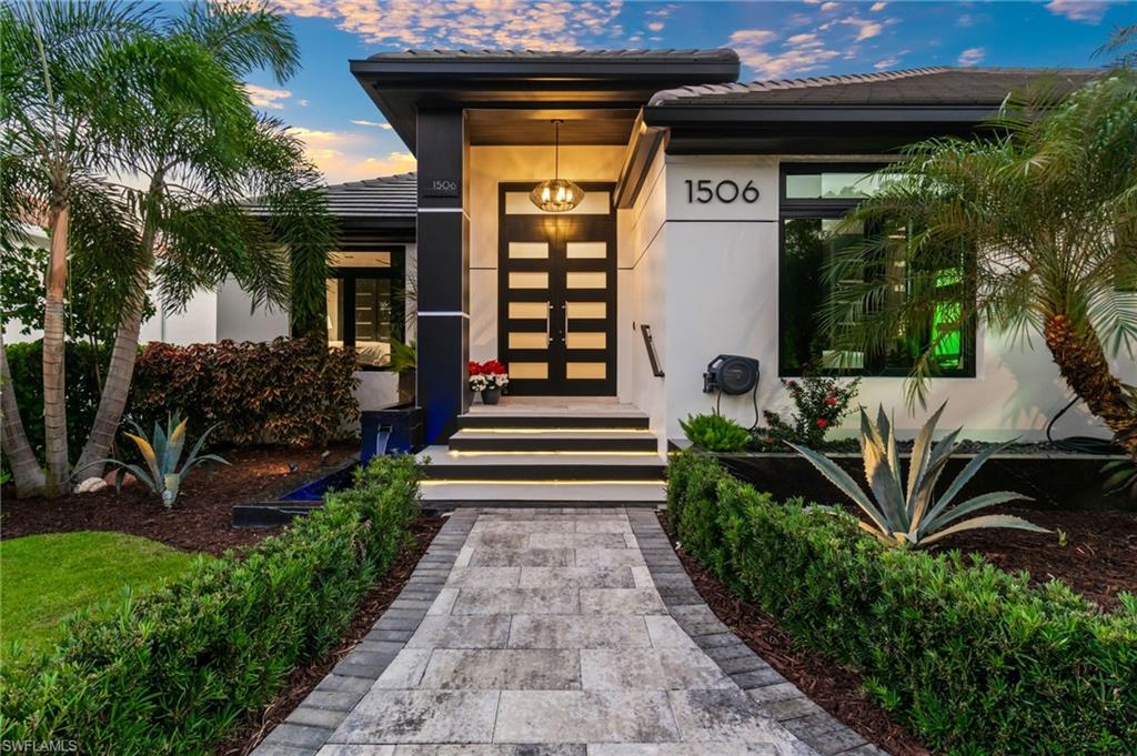 1506 Jewel Naples, FL 34102 - Photo 3 of 49 a front view of a house with garden and seating area