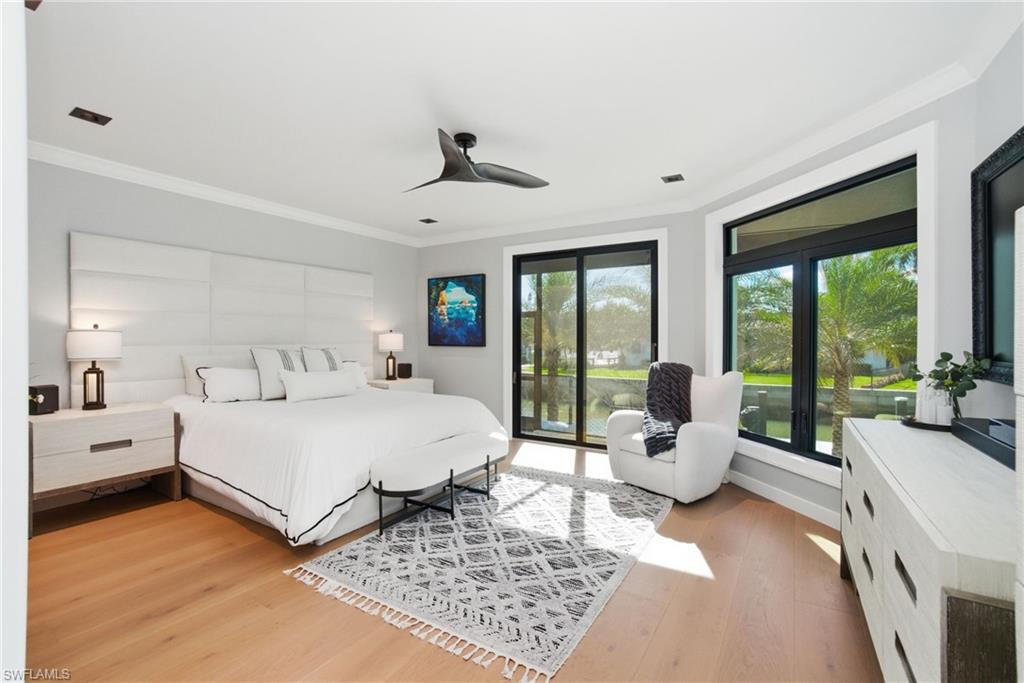 1506 Jewel Naples, FL 34102 - Photo 10 of 49 a large bedroom with a bed and large windows