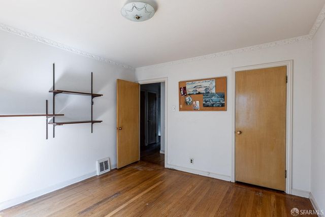 a view of a room with wooden floor
