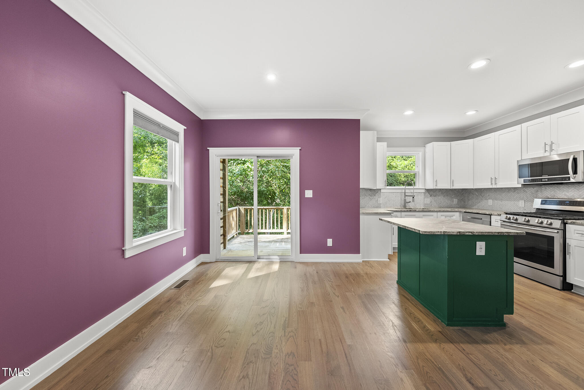 1529 Battery Drive Raleigh, NC 27610 - Photo 8 of 34 a open kitchen with granite countertop a stove top oven a sink and dishwasher with wooden floor