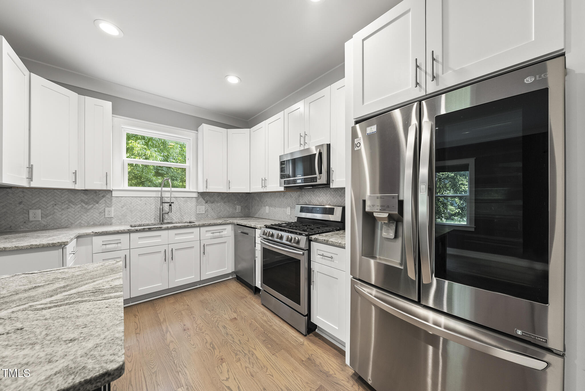 1529 Battery Drive Raleigh, NC 27610 - Photo 10 of 34 a kitchen with granite countertop stainless steel appliances and window