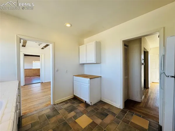 a view of a room with wooden floor