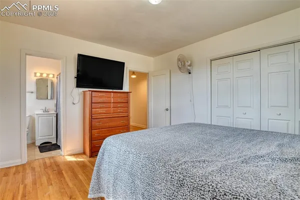 a bedroom with a bed and a flat screen tv