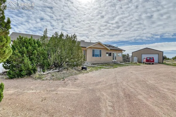 a house with lots of trees in the background