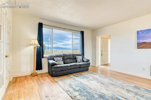 a living room with furniture and a large window