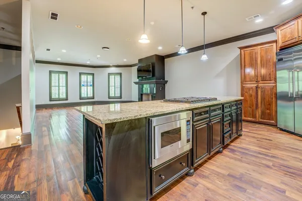 a kitchen with a stove and a wooden floor