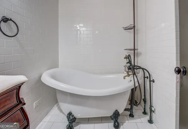 a bathroom with a bathtub and shower