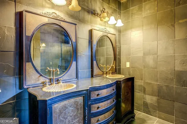 a bathroom with a sink a mirror and vanity