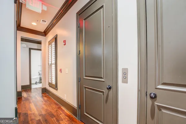 a view of a hallway with wooden floor