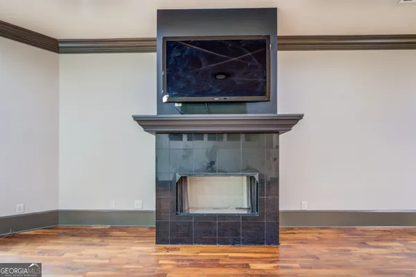 a living room with a fireplace and a wooden floor