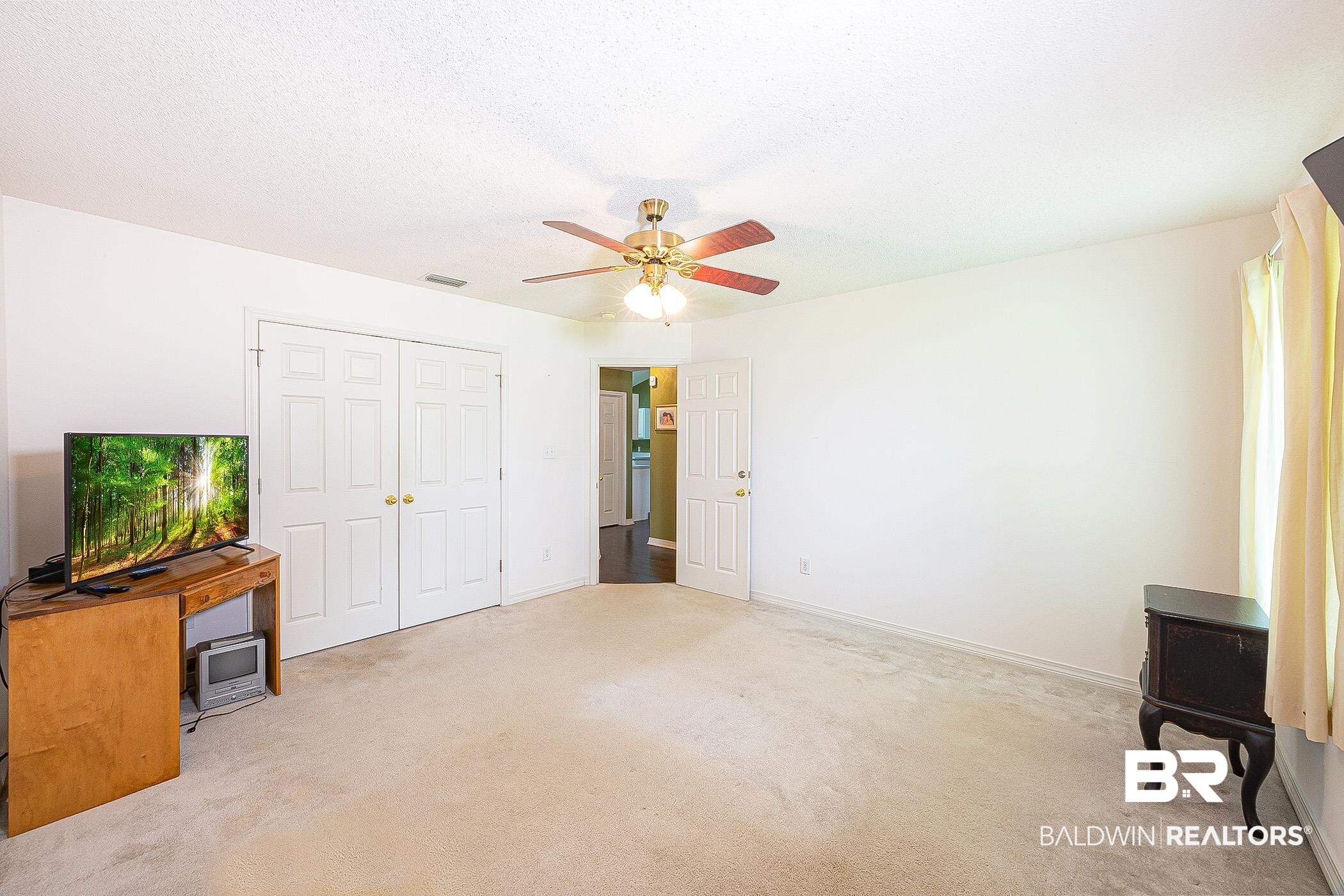 16154 Parke Boulevard Foley, AL 36535 - Photo 27 of 44 Carpeted bedroom featuring a closet and ceiling fan