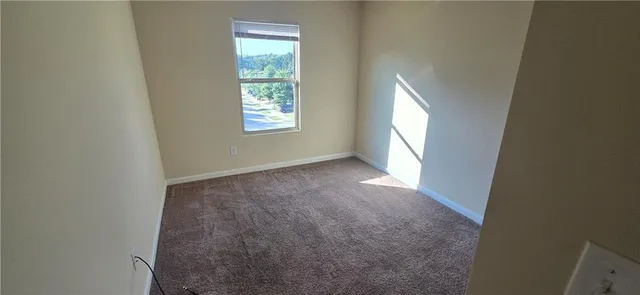 a view of an empty room and closet area