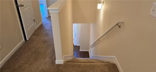 a spacious bathroom with a granite countertop toilet sink and mirror