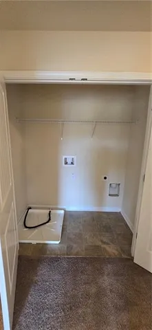 a backyard of a house with barbeque oven and glass top table